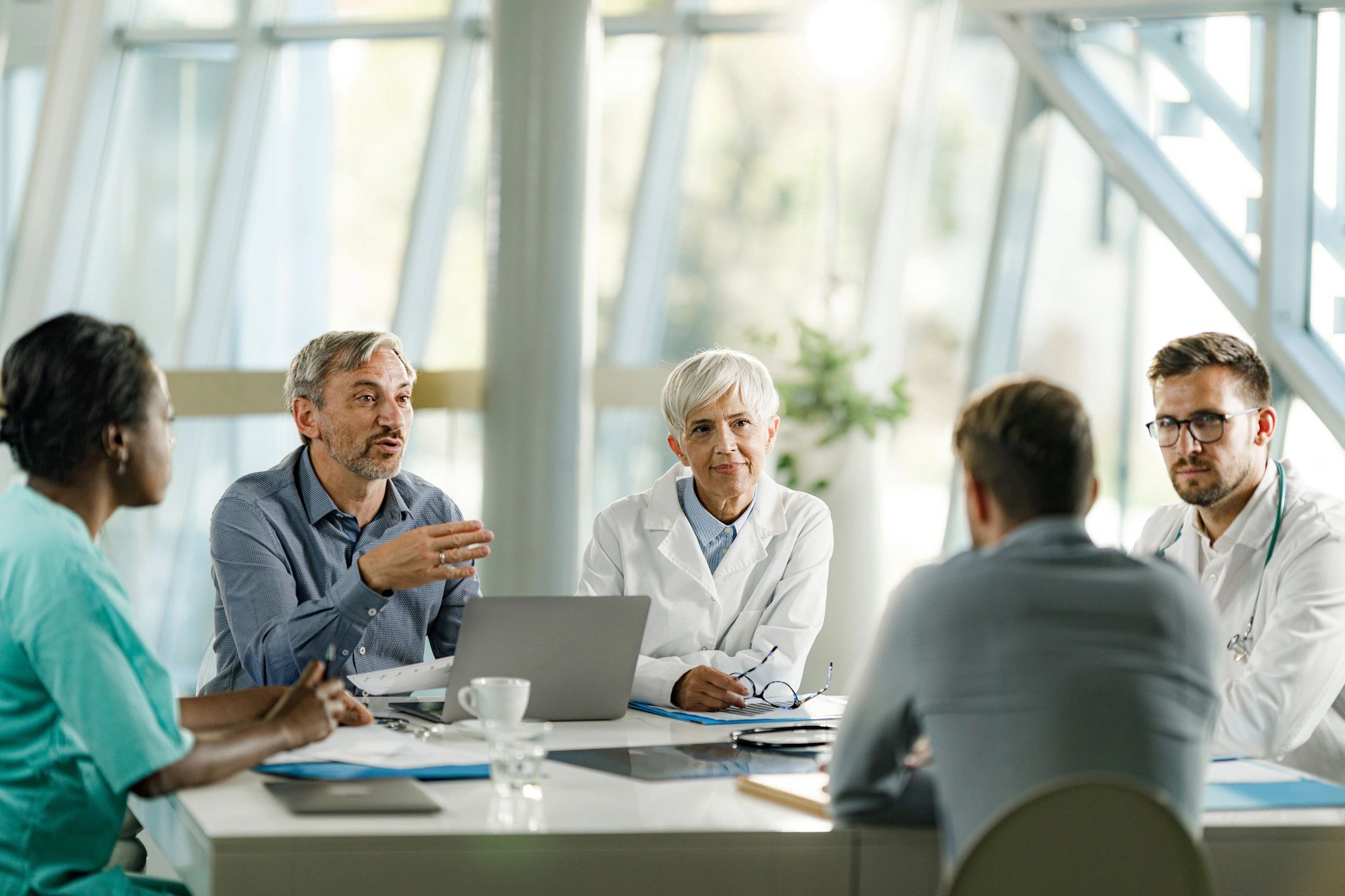 Editorial director in discussion with healthcare colleagues